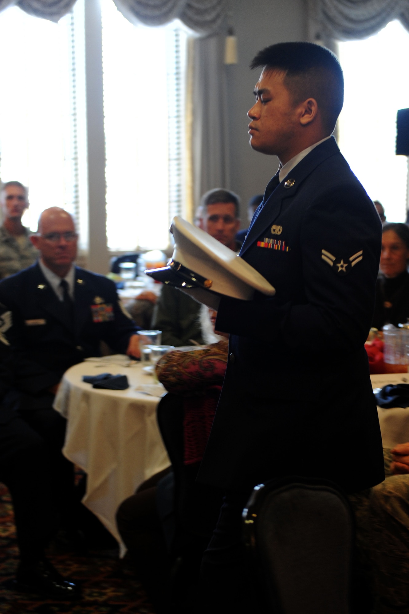 Airman 1st Class Delphia Ith carries the Marine Corps hat during the POW/MIA Luncheon at Langley Air Force Base, Va., Sept. 20, 2013. The four branches of military service were represented by hats placed on a table during the POW/MIA ceremony. (U.S. Air Force photo by Senior Airman Brittany Paerschke-O’Brien/Released)