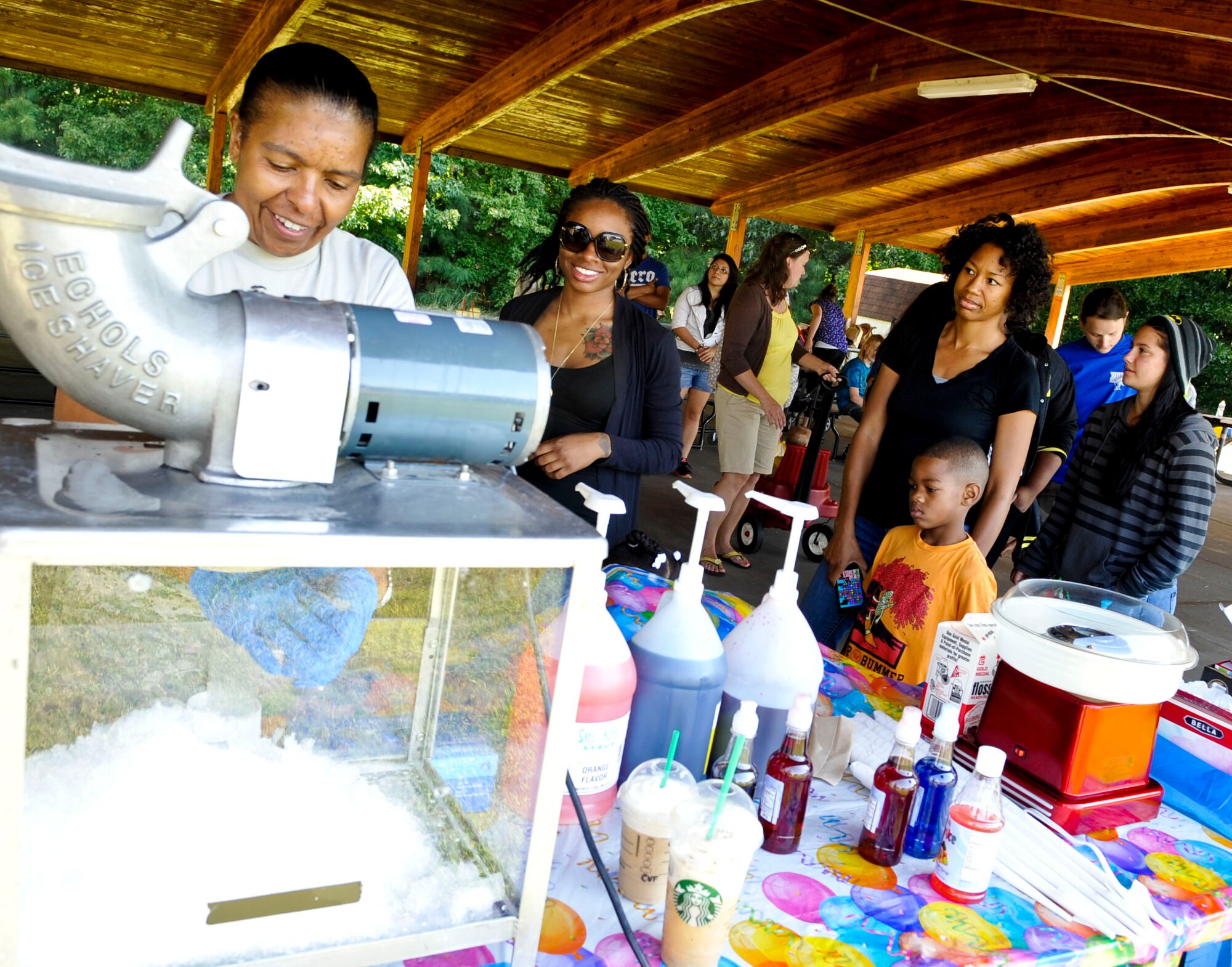 Members of the 159th Aviation Regiment line up for snow cones during their family day events at Fort Eustis, Va., Sept. 21, 2013.  The unit’s family day was held in conjunction with two changes of command in order to say goodbye to previous commanders and welcome in new ones. (U.S. Air Force photo by Staff Sgt. Wesley Farnsworth/Released)