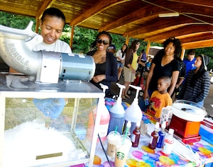Members of the 159th Aviation Regiment line up for snow cones during their family day events at Fort Eustis, Va., Sept. 21, 2013.  The unit’s family day was held in conjunction with two changes of command in order to say goodbye to previous commanders and welcome in new ones. (U.S. Air Force photo by Staff Sgt. Wesley Farnsworth/Released)
