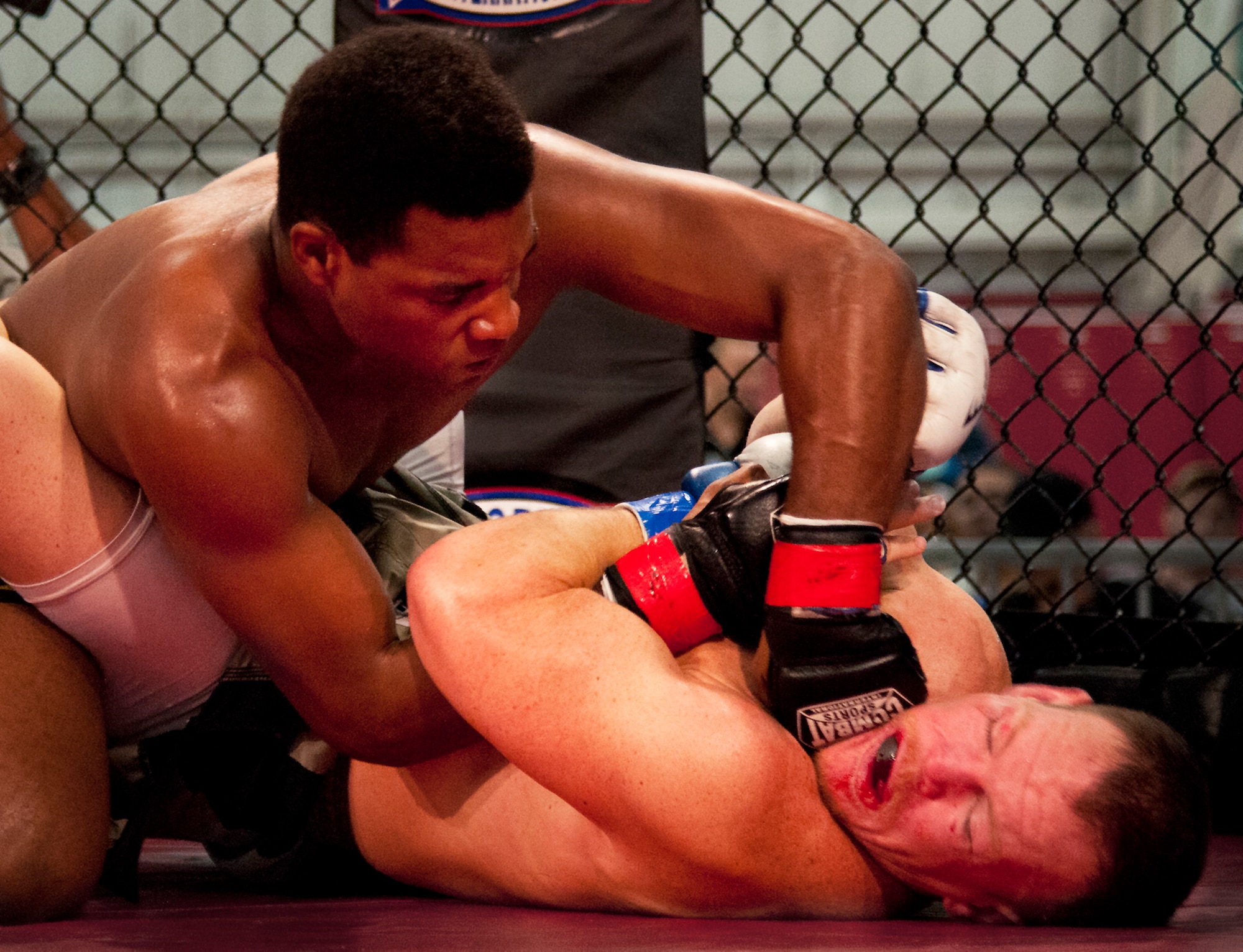 Andre Hall punches Darryl Scott in the face during the first fight of Strike Fight II Sept. 21 at Eglin Air Force Base, Fla.  Hall won the bout by technical knockout.  This was Eglin’s second mixed martial arts event.  (U.S. Air Force photo/Samuel King Jr.)  