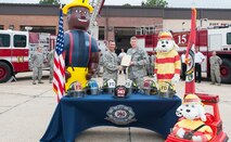 U.S. Air Force Col. Chad P. Franks, 23d Wing commander, signs a Fire Prevention Proclamation at Moody Air Force Base, Ga. Sept. 23, 2013. Fred the Firefighter and Sparky the Fire Dog attended the signing to give a preview of Fire Prevention Week, which is scheduled for Oct. 6 to 12.(U.S. Air Force photo by Airman Dillian M. Bamman/Released)