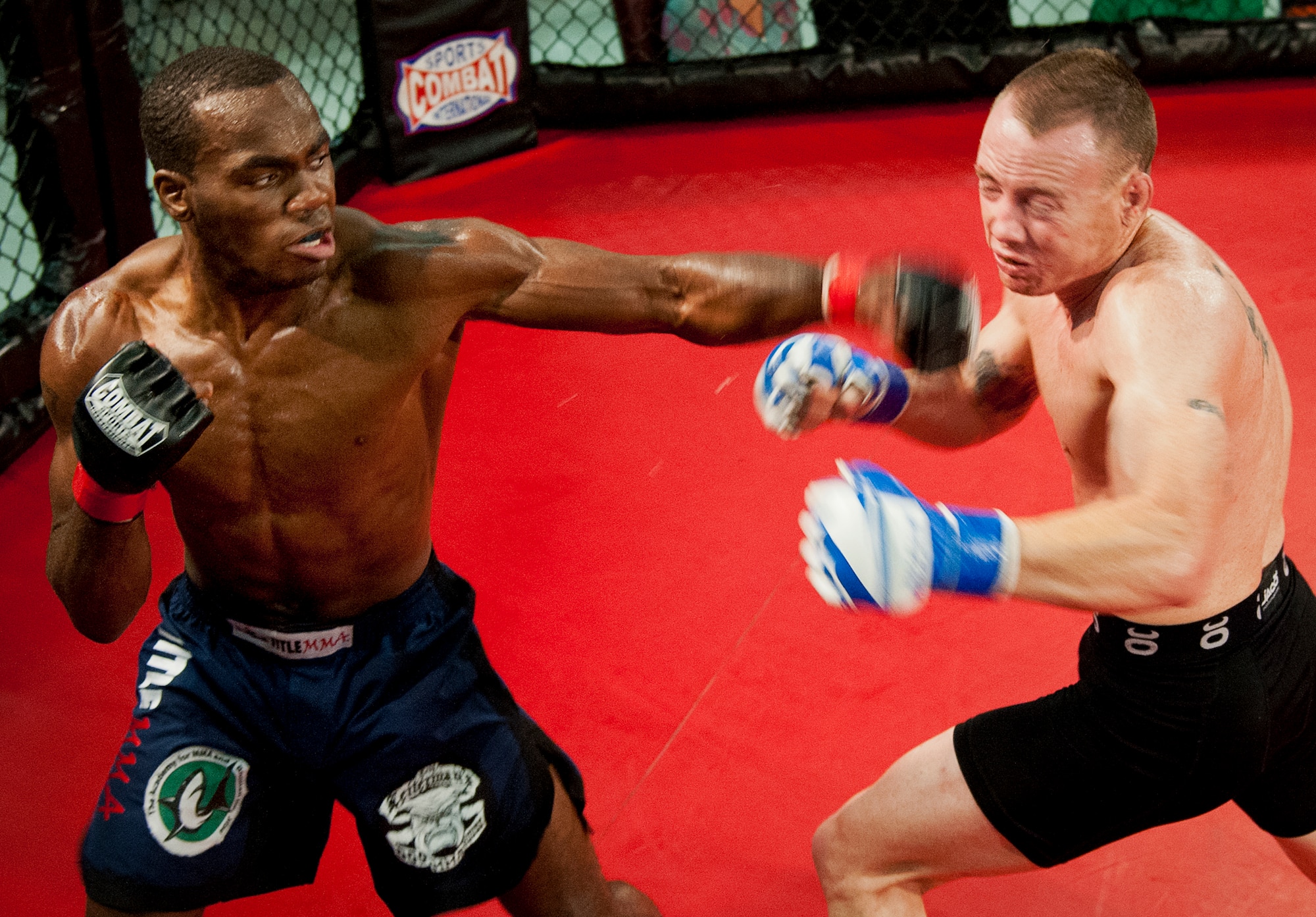 Michael Roberts hits Tony Conners with a left jab during their bout at Strike Fight II Sept. 21 at Eglin Air Force Base, Fla.  Roberts won the fight with a rear-naked choke hold.  Conners is a Marine and Roberts is active-duty Navy.  This was Eglin’s second mixed martial arts event.  (U.S. Air Force photo/Samuel King Jr.)