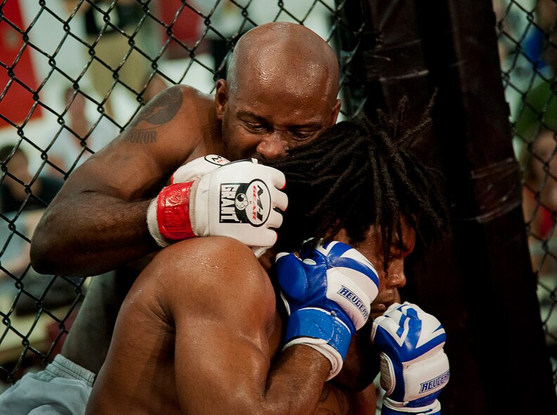 Wesley Herbert tightens down his choke-hold on Brandon Arington during their bout at Strike Fight II Sept. 21 at Eglin Air Force Base, Fla. Herbert won the fight by a unanimous decision. Eglin’s second mixed martial arts event. (U.S. Air Force photo/Samuel King Jr.) 