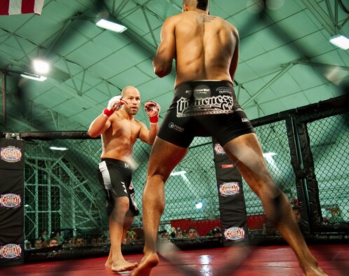 Danny Ruiz looks for a way to attack Ryan Hodge in their bout at Strike Fight II Sept. 21 at Eglin Air Force Base, Fla.  Ruiz won by knockout in the first round.  Ruiz is an Air Force reservist with the 919th Special Operations Logistics Readiness Squadron at Duke Field Fla. This was Eglin’s second mixed martial arts event.   (U.S. Air Force photo/Samuel King Jr.)
