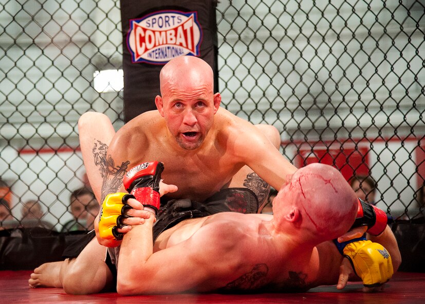 Chris Ortiz tries to subdue Brad Collins during their match at Strike Fight II Sept. 21 at Eglin Air Force Base, Fla.  Collins would later win the bout with an armbar submission. This was Eglin’s second mixed martial arts event.   (U.S. Air Force photo/Samuel King Jr.)