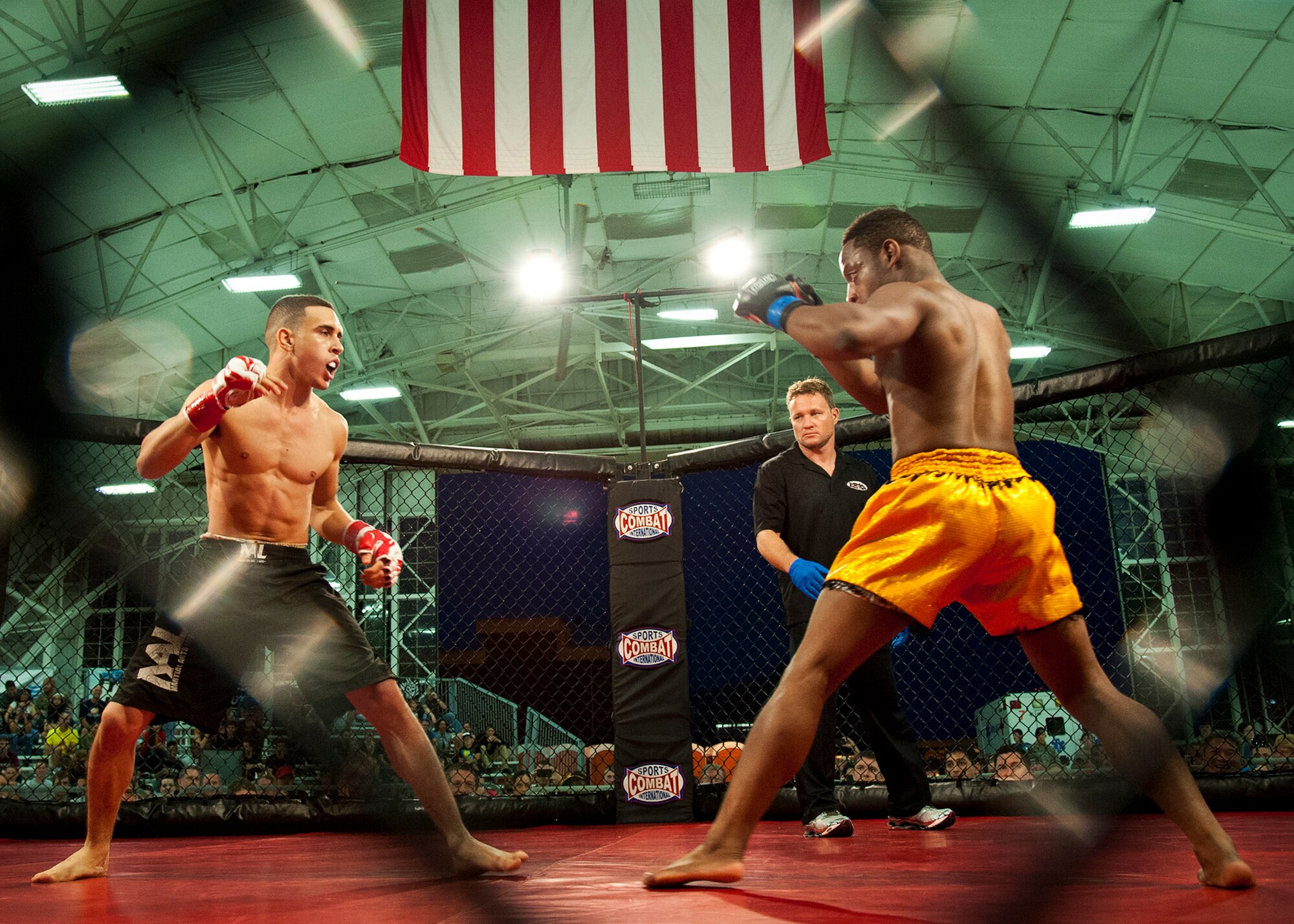 Trey Slaton and Jerlad Colbert square off in the middle of the octagon in the second bout of Strike Fight II Sept. 21 at Eglin Air Force Base, Fla.  Slaton and Colbert fought to a decision, in which Colbert was pronounced the winner.  This was Eglin’s second mixed martial arts event.  (U.S. Air Force photo/Samuel King Jr.)
