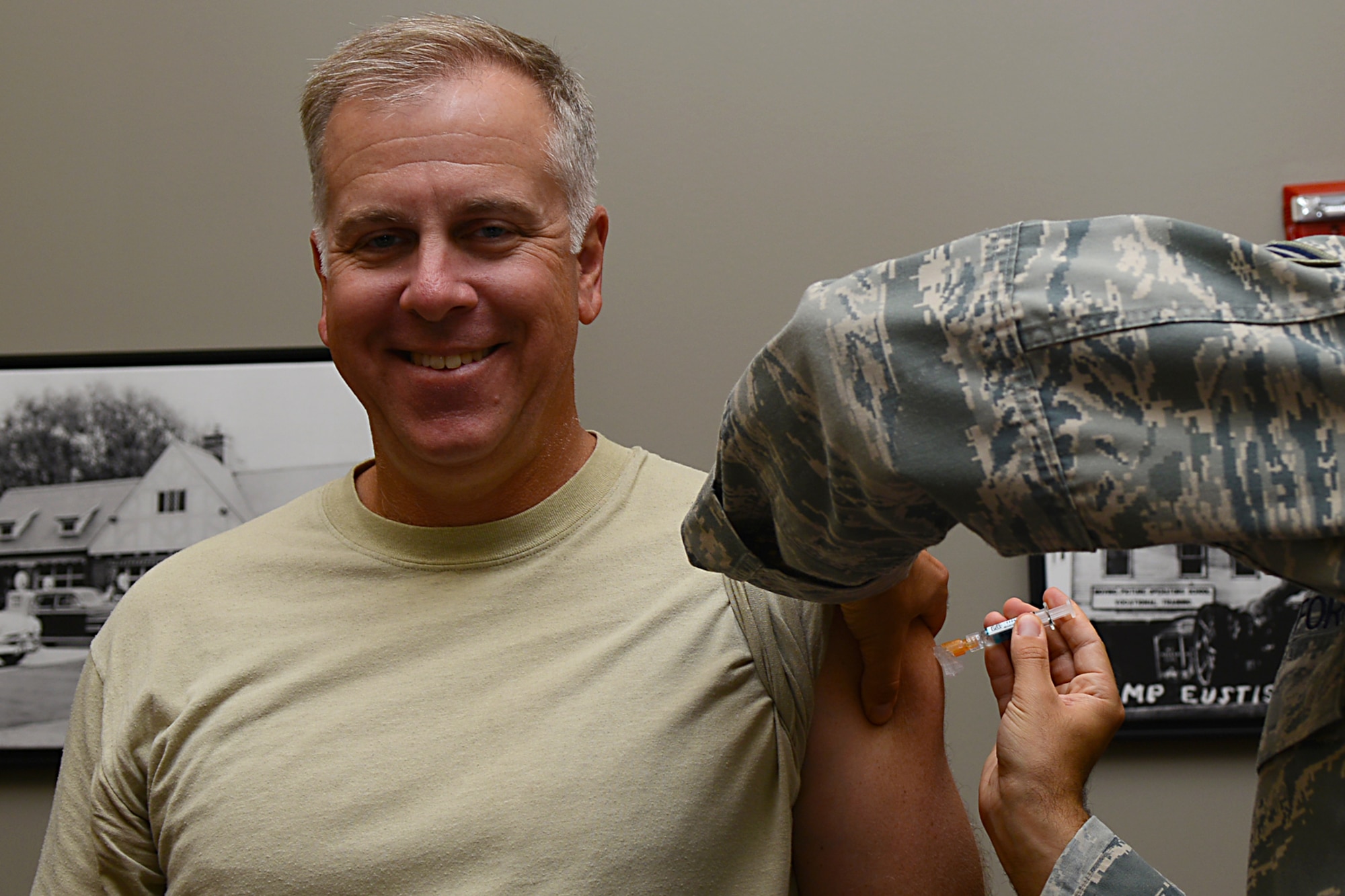 U.S. Air Force Col. John J. Allen Jr., 633rd Air Base Wing commander, receives a flu shot from Airman 1st Class Jesse Hansen, 633rd Medical Operations Squadron internal medicine technician, at Langley Air Force Base, Va., Sept. 20, 2013. Flu vaccinations are set to be available for active-duty personneland government employees at Langley Sept. 25 and 27. For more information on the importance of the flu vaccine, call the 633rd Public Health clinic at 764-6731 or the McDonald Army Health Center Immunization clinic at 314-7673. (U.S. Air Force photo by Airman 1st Class Victoria H. Taylor/Released)