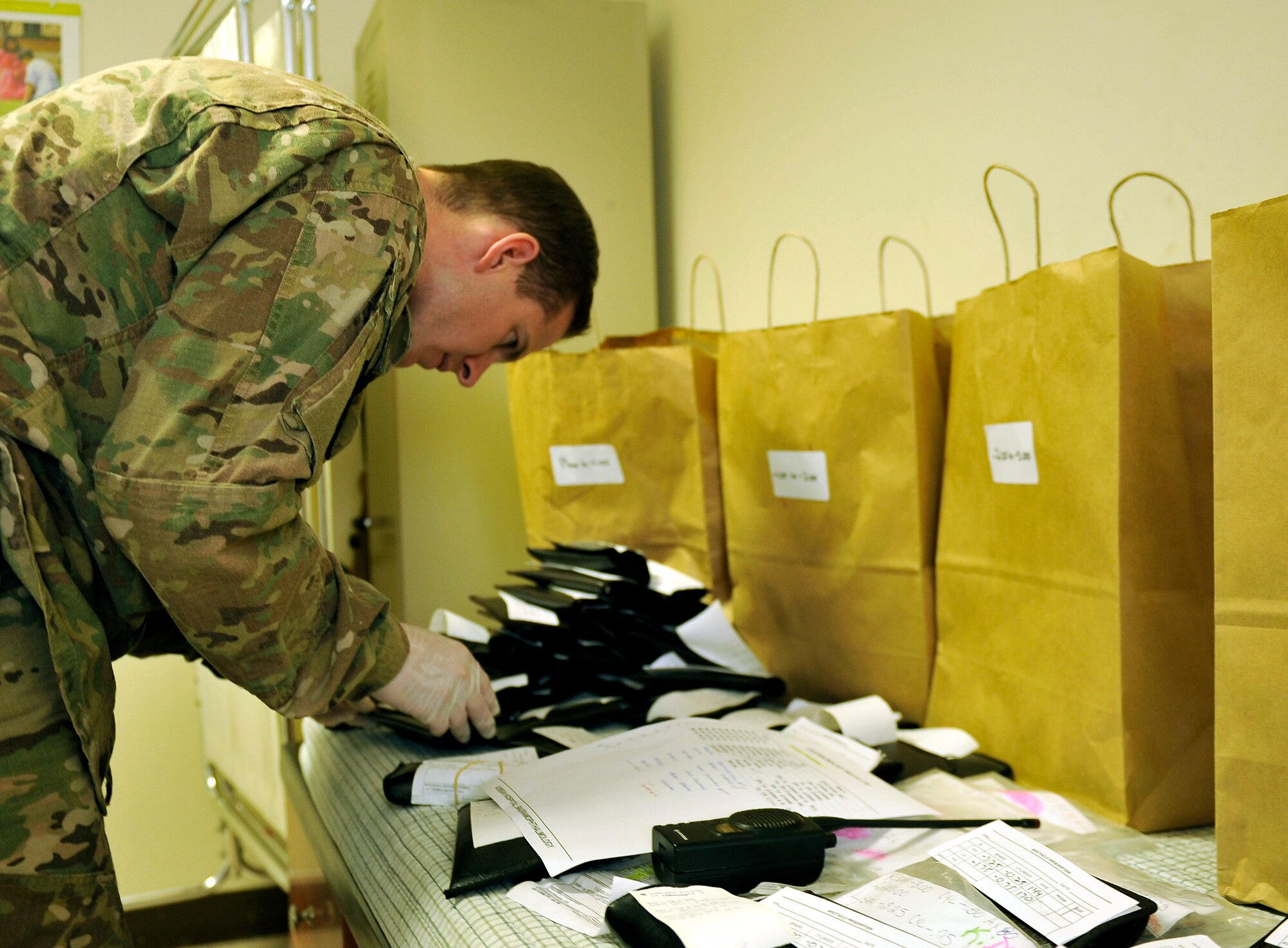 Maj. Marcus Neuffer, 455th Expeditionary Medical Group ophthalmologist, searches through a pile of donated prescription eye glasses for an Afghan patient during an eye glasses clinic in the Korean Hospital on Bagram Air Field, Afghanistan, Sept. 18. Five months ago after arriving on Bagram, he established a program to provide glasses to Afghan and coalition members in need. The glasses come from former patients and non-profits. This is the second time they have held an eye glasses clinic here. He is deployed from Keesler Air Force Base, Miss. (U.S. Air Force photo/ Staff Sgt. Stephenie Wade)




