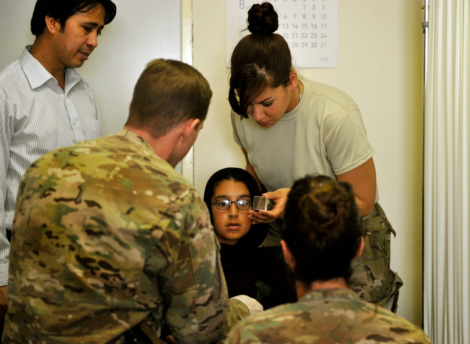 Maj. Marcus Neuffer, 455th Expeditionary Medical Group ophthalmologist, and his technician, Airman 1st Class Chellbie Gonzales, conduct an eye exam on a 10-year-old girl before determining her prescription in the Korean Hospital on Bagram Air Field, Afghanistan, Sept. 18. The girl was diagnosed with crossed eyes two months ago. Both Maj Neuffer and A1C Gonzales are deployed from Keesler Air Force Base, Miss. (U.S. Air Force photo/ Staff Sgt. Stephenie Wade)
