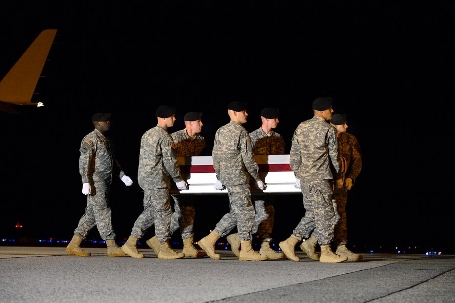 A U.S. Army carry team transfers the remains of Army Spc. Joshua J. Strickland, of Woodstock, Ga., at Dover Air Force Base, Del., Sept. 23, 2013. Strickland was assigned to the Company D, 1st Special Forces Battalion, 1st Special Forces Group Fort Lewis, Wash. (U.S. Air Force photo/David Tucker)