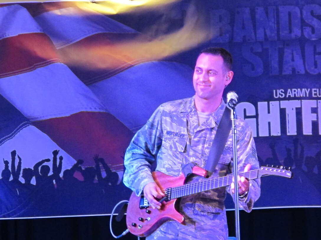 SSgt Alex Nikiforoff captivates the audience during a guitar solo.  Touch 'n Go and the U.S. Army Band Europe Band's Nightfire traded songs through the decades for this celebration.  