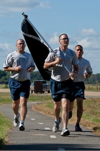 U.S. Air Force Airmen run during the POW/MIA 24-hour vigil at Langley Air Force Base, Va., Sept. 19, 2013. Airmen were able to walk or run a portion of the full 7.4 mile path through Langley AFB. The run ended at 10 a.m. Sept. 20 at the Langley POW/MIA memorial. (U.S. Air Force photo by Staff Sgt. Stephanie Rubi/Released) 