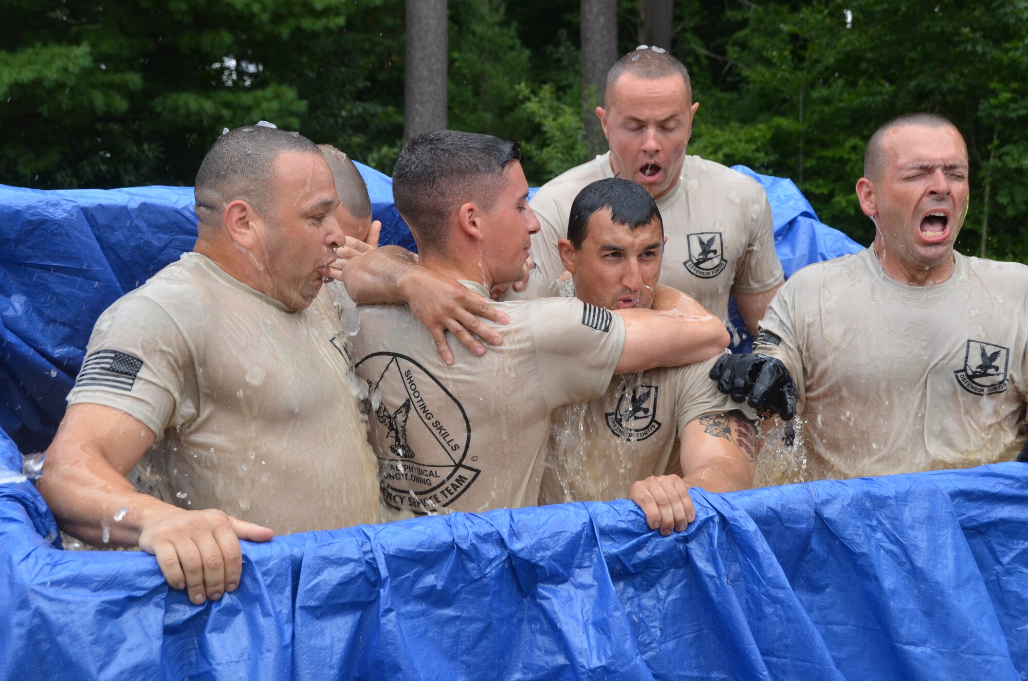 Members of the 103rd Security Forces Squadron emergency services team endure an ice-water plunge at the West Hartford Reservoir as part of the Connecticut SWAT Challenge Aug. 22, 2013. The ice bath was just one of many physically grueling obstacles competitors faced. (U.S. Air National Guard Photo by Maj. Bryon Turner)