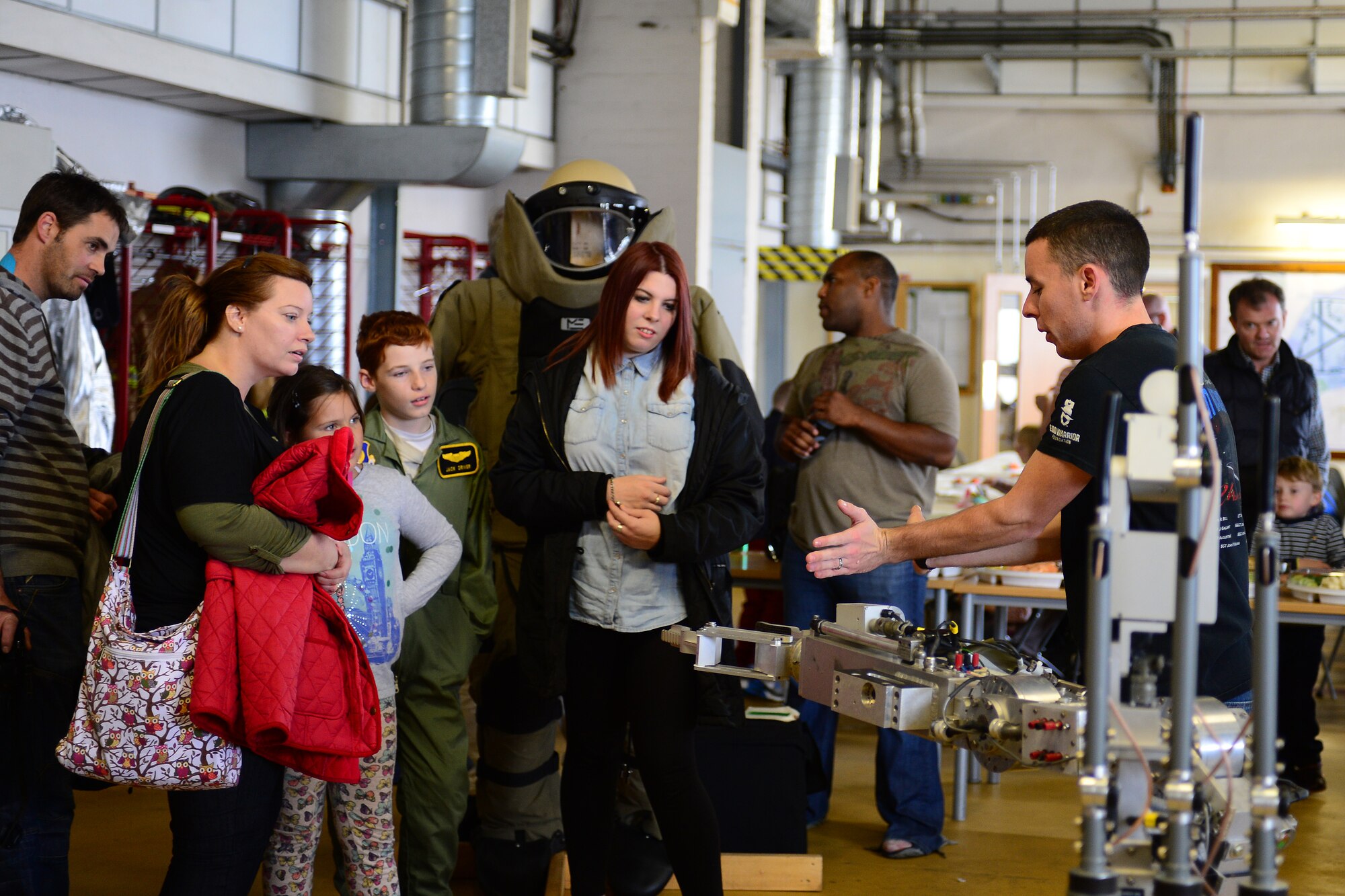 Airman 1st Class Trenton Hawk, 48th Civil Engineer Squadron explosive ordnance disposal apprentice, explains the use of an Air Force medium-sized robot to children and families from East Anglia’s Children’s Hospices at Royal Air Force Lakenheath, England, Sept. 21, 2013. More than 30 children and their families were invited to Children’s Hospice Family Day, which allowed children in hospice care and their families a day of fun and a break from routine doctor and hospital visits. (U.S. Air Force photo by Airman 1st Class Dana J. Butler/Released)
