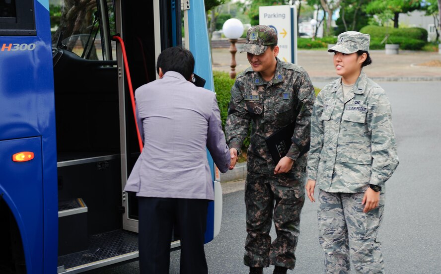 First Lt. Son Lee, 8th Fighter Wing Public Affairs deputy chief, right, and Republic of Korea air force 2nd Lt . Hyung Jun Im, 38th Fighter Group Public Affairs deputy chief, greet members of the local media at Gunsan, Republic of Korea Sept. 24, 2013. The base hosted the local media to showcase Kunsan Air Base’s combined mission. (U.S. Air Force photo by Senior Airman Armando A. Schwier-Morales/ Released)