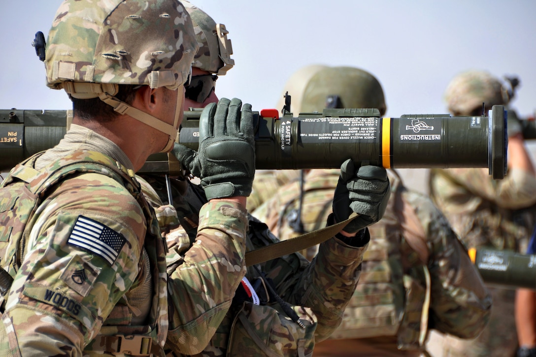 U.S. Army Staff Sgt. Anthony Woods, left, the safety officer, watches U.S. Army Pfc. Prieto prepare to fire an M136 AT-4 anti-tank 84mm rocket launcher during weapons and explosives training on Forward Operating Base Farah, Afghanistan, Sept. 20, 2013. Woods is assigned to the 1st Infantry Division's Company B, 2nd Battalion 1st Infantry Regiment, and Prieto is assigned to Provincial Reconstruction Team Farah.