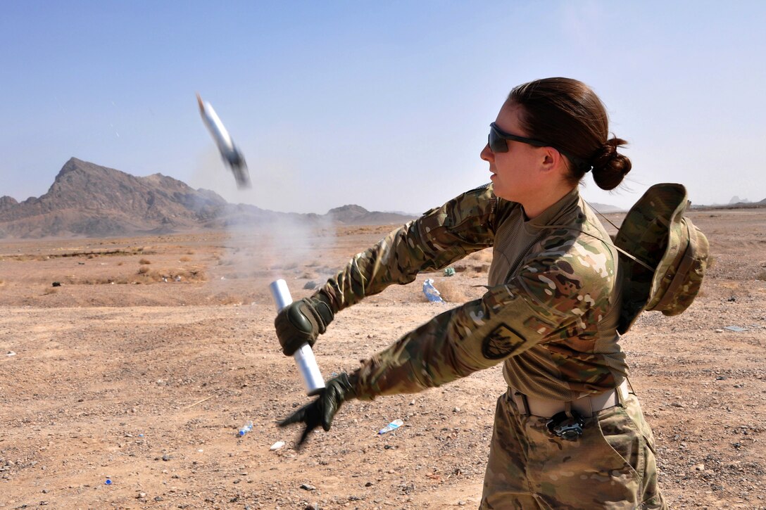 U.S. Navy Petty Officer 3rd Class Ashley North actuates a parachute signal flare during weapons and explosives training on Forward Operating Base Farah, Afghanistan, Sept. 20, 2013. North, an operations specialist, is assigned to Provincial Reconstruction Team Farah.