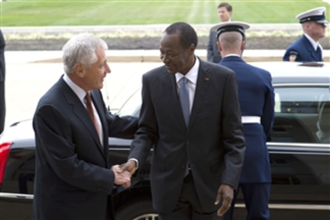 Secretary of Defense Chuck Hagel, left, greets Burkina Faso President Blaise Compaore upon his arrival at the Pentagon in Arlington, Va., on Sept. 23, 2013.  The two leaders will meet to discuss security issues of mutual importance.  