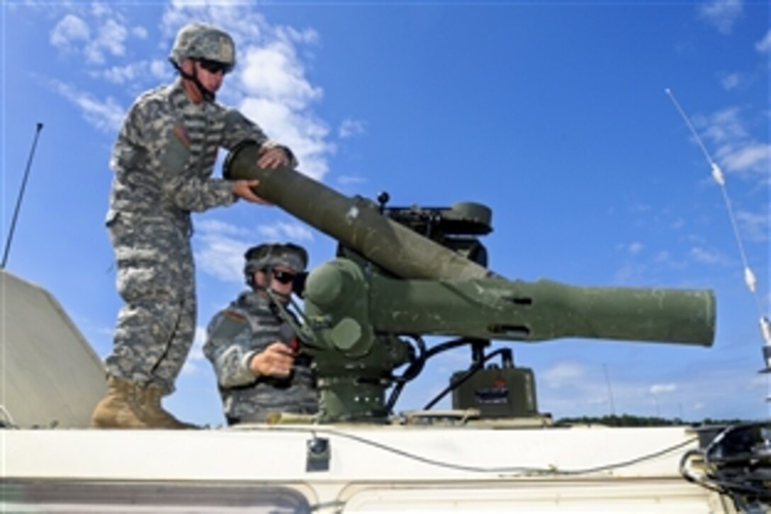 Army Spcs. Justin Reynolds, left, and Jon Haley reload a training round into an tow missile system during a live-fire exercise at the Georgia Garrison Training Center on Fort Stewart, Ga., Sept. 19, 2013. Reynolds and Haley, cavalry scouts, are assigned to the Georgia Army National Guard's 1st Squadron, 108th Cavalry Regiment.