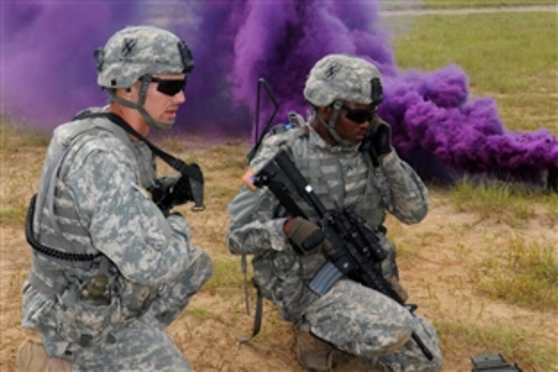 Army 2nd Lt. Tye Walden, left, relays radio traffic to Army Pvt. David Lemons during a combined arms live-fire exercise at the Georgia Garrison Training Center on Fort Stewart, Ga., Sept. 19, 2013. Walden, a platoon leader and Lemons, are assigned to the Georgia Army National Guard's 1st Squadron, 108th Cavalry Regiment.