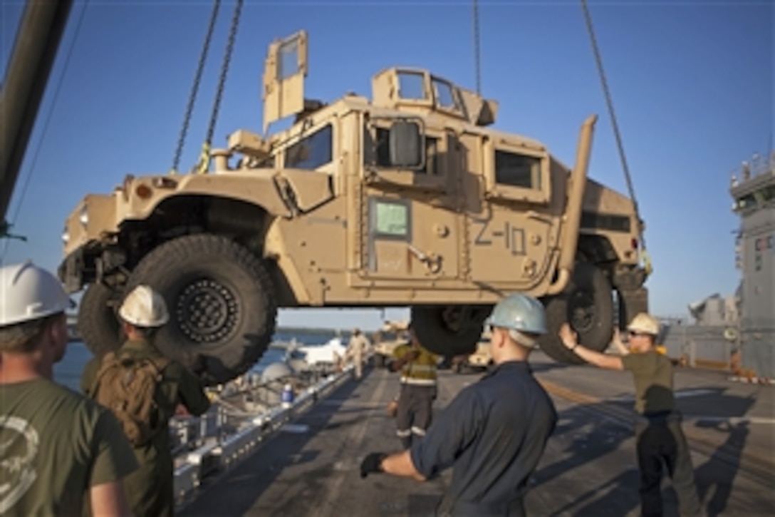 U.S. Marines guide a Humvee onto the amphibious assault ship USS Bonhomme Richard during Koolendong 2013 in Darwin, Australia, Sept. 9, 2013. Koolendong is an amphibious and live-fire exercise designed to increase interoperability between the U.S. Marine Corps and Australian Defense Force. 