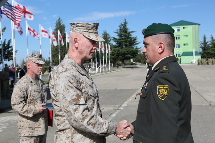 Lieutenant General Richard Tryon, commander, U.S. Marine Forces, Europe presents Georgian LtCol Terashvili and LtCol Argvliani with awards for their actions during a recent deployment to Afghanistan Sept 19, 2013.  The award presentations were incorporated into a departure ceremony for the 10th and 11th rotations of Georgian battalions as they prepare to deploy to the Helmand Province. The LtCol’s trained with U.S. Marines prior to their successful deployment under the Georgian Deployment Program – ISAF commonly referred to as GDP-I.