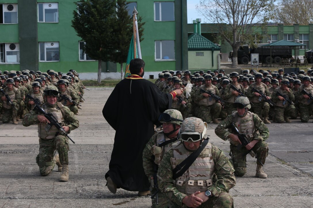 A battalion chaplain blesses the formation of troops during a departure ceremony held at the Vaziani Training Area Sept. 19, 2013. Having completed six months of training, the 31st and Batumi battalions will now deploy to the Helmand Province of Afghanistan where they have been fighting shoulder to shoulder with U.S. Marines since 2009. The training is officially known as the Georgian Deployment Program – ISAF and this marks the 10th and 11th rotations of Georgian soldiers who have trained under the program.