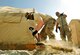 Capt. Wesley Parker, 455th Expeditionary Communications Squadron, operations flight commander, excavates trenches to hold conduit on Bagram Airfield, Afghanistan. The conduit will protect the fiber and copper cable running underground to the tents. He is deployed from Tinker Air Force Base, Okla., and is a native of Humble, Texas.