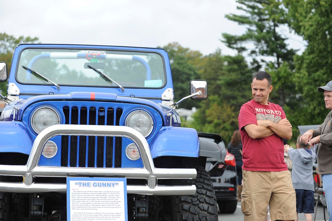 A spectator observes a Jeep Wrangler on display during the 2nd Annual Quantico Car Show aboard Marine Corps Base Quantico on Sept. 21, 2013. This vehicle did not win a prize. 