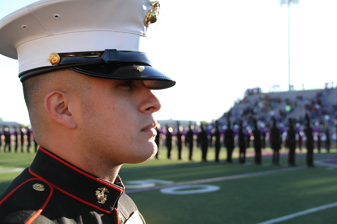 Sgt. Jose Gomez, recruiter, RS Indianapolis, looks on as the colors are marched onto the field before the Great American Rivalry Series game bewteen Ben Davis and Warren Central at the Ben Davis football field Sep.13.