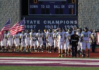 Sgt. Jose Gomez, recruiter, RS Indianapolis, leads the Warren Central varisty football team onto the Ben Davis football field to begin the Great American Rivalry Series game between Ben Davis and Warren Central Sep. 13.