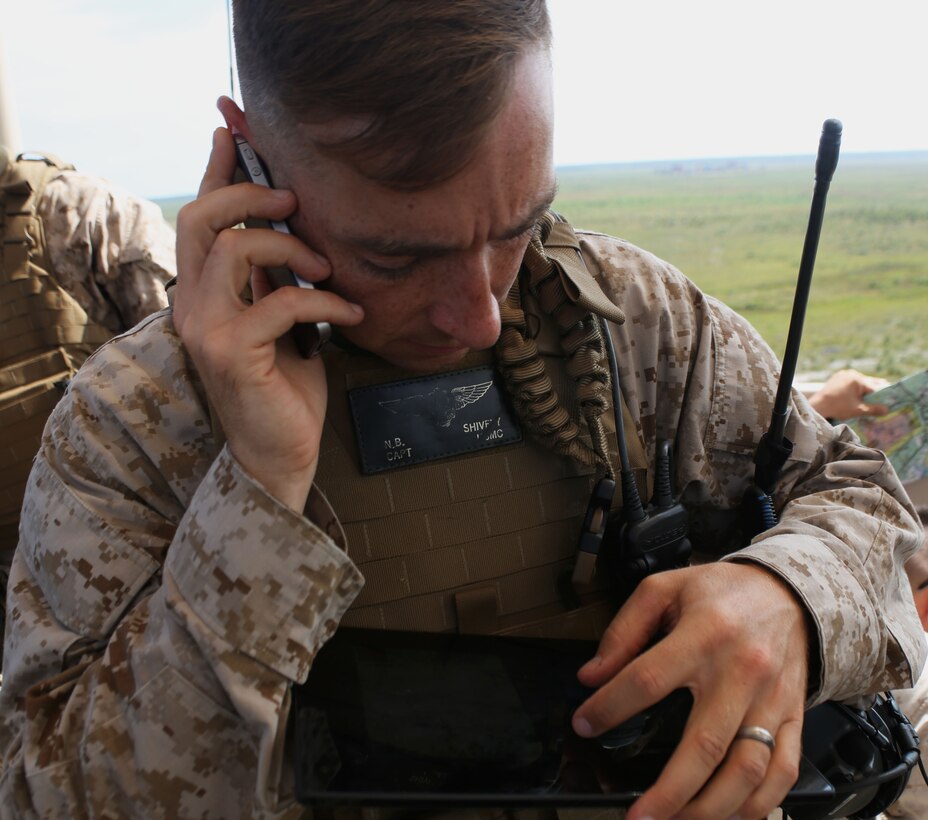 Captain Nathan Shivley, an air officer for 2nd Air Naval Gunfire Liaison Company, II Marine Expeditionary Force, discusses the results of a munitions drop during a close air support exercise Sept. 11. The exercise involved Marines and sailors of 2nd ANGLICO working with pilots from the 333rd Fighter Squadron from Seymour Johnson Air Force Base.