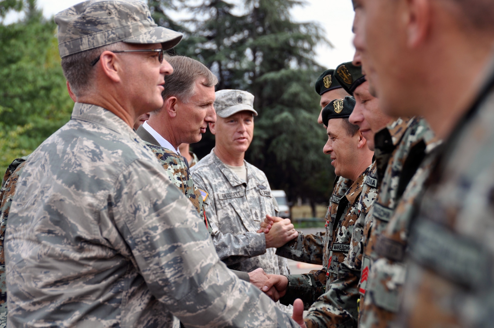 U.S. Air Force Maj. Gen. Steven Cray, the adjutant general of the Vermont National Guard, U.S. Ambassador Paul Wholers, and U.S. Army Sgt. Maj. Forrest Glodgett pass out medals and accolades to 79 Soldiers from the Army of the Republic of Macedonia at Illenden Barracks, Skopje, Macedonia, Sept. 12, 2013.