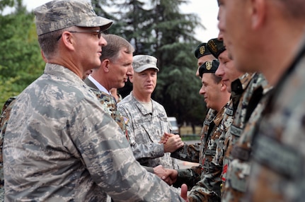 U.S. Air Force Maj. Gen. Steven Cray, the adjutant general of the Vermont National Guard, U.S. Ambassador Paul Wholers, and U.S. Army Sgt. Maj. Forrest Glodgett pass out medals and accolades to 79 Soldiers from the Army of the Republic of Macedonia at Illenden Barracks, Skopje, Macedonia, Sept. 12, 2013.