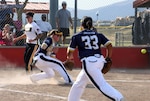 An All-Army Women's base runner beats a throw home as the All-Navy catcher waits for the ball during the Armed Forces Softball Tournament Sept. 15 at Cannoneer Complex.