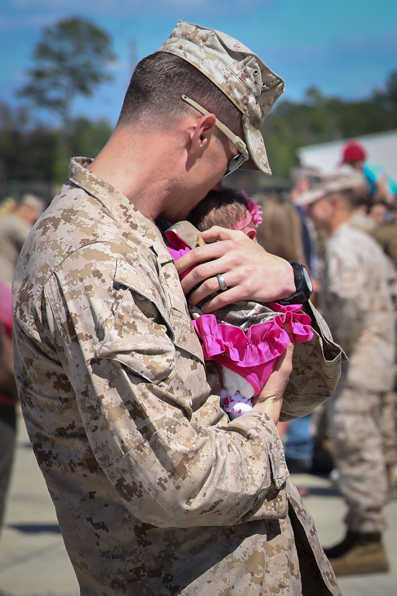 Cpl. Chris Kent, a native of Chipley, Fla., and a team leader with Golf Company, 2nd Battalion, 8th Marine Regiment, holds his 2-day-old daughter at the unit’s homecoming from Afghanistan, aboard Marine Corps Base Camp Lejeune Sept. 23, 2013. Kent was a team leader for the six-month deployment to Afghanistan. This was the first time Kent had the opportunity to meet his daughter. The 75 Marines and sailors who returned home were the advanced party for 2nd Bn., 8th Marines.