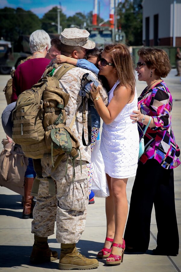 Staff Sgt. John Forero, a native of Queens, N.Y., and the S-2 chief for 2nd Battalion, 8th Marine Regiment, greets his wife and daughter after returning from a six-month deployment to Afghanistan, Sept. 23, 2013 aboard Marine Corps Base Camp Lejeune. With this being Forero’s fourth deployment, he said deploying gets harder once you have a family. The 75 Marines and sailors who returned home were the advanced party for 2nd Bn., 8th Marines.