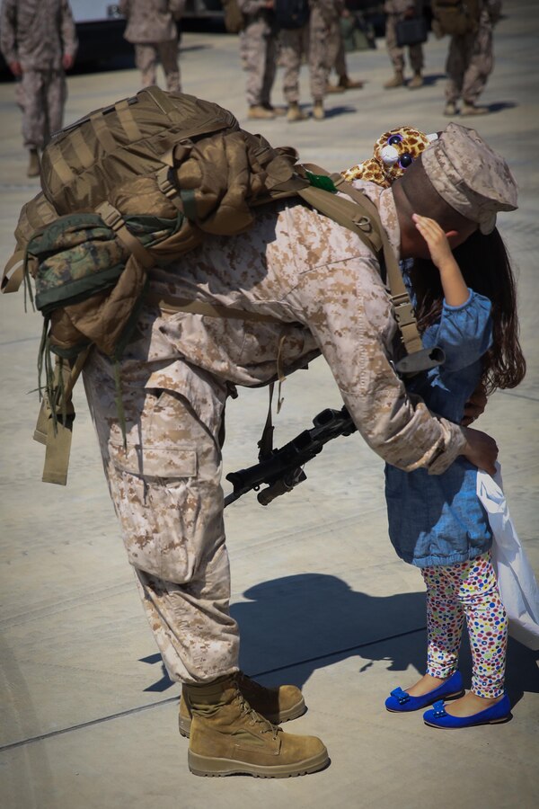 Staff Sgt. John Forero, the S-2 chief for 2nd Battalion, 8th Marine Regiment, and Queens, N.Y., native, hugs his daughter after returning home from Afghanistan Sept. 23, 2013, aboard Marine Corps Base Camp Lejeune. In reference to Forero’s fourth deployment he said, deploying gets harder when you have a family. The 75 Marines and sailors who returned home were the advanced party for 2nd Bn., 8th Marines.