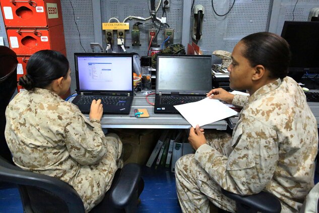 U.S. Marines Cpl. Didivalis Cruz, maintenance management clerk, and Staff Sgt. Sadys Corcino, maintenance management chief with 13th Marine Expeditionary Unit, analyse task and transaction records kept using the Global Combat Support System-Marine Corps aboard the USS Boxer, Sept. 25. The Marines and Sailors with 13th MEU will deploy for several months in support of theater requirements of Geographic Combatant Commanders. (Marine Corps Photos by Sgt. Jennifer Pirante/RELEASED)
