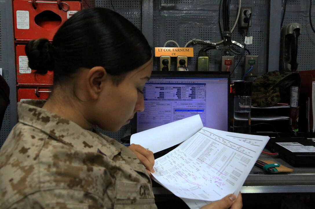 U.S. Marine Cpl. Didivalis Cruz, maintenance management clerk with 13th Marine Expeditionary Unit, analyses task and transaction records kept using the Global Combat Support System-Marine Corps aboard the USS Boxer, Sept. 25. The Marines and Sailors with 13th MEU will deploy for several months in support of theater requirements of Geographic Combatant Commanders. (Marine Corps Photos by Sgt. Jennifer Pirante/RELEASED)