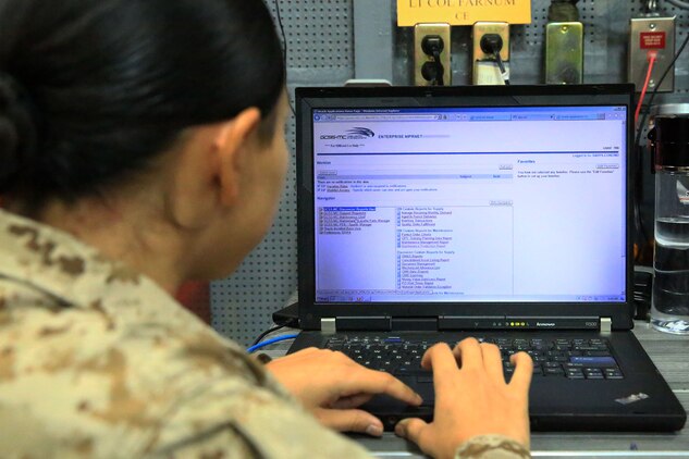 U.S. Marine Cpl. Didivalis Cruz, maintenance management clerk with 13th Marine Expeditionary Unit, analyses task and transaction records kept using the Global Combat Support System-Marine Corps aboard the USS Boxer, Sept. 25. The Marines and Sailors with 13th MEU will deploy for several months in support of theater requirements of Geographic Combatant Commanders. (Marine Corps Photos by Sgt. Jennifer Pirante/RELEASED)