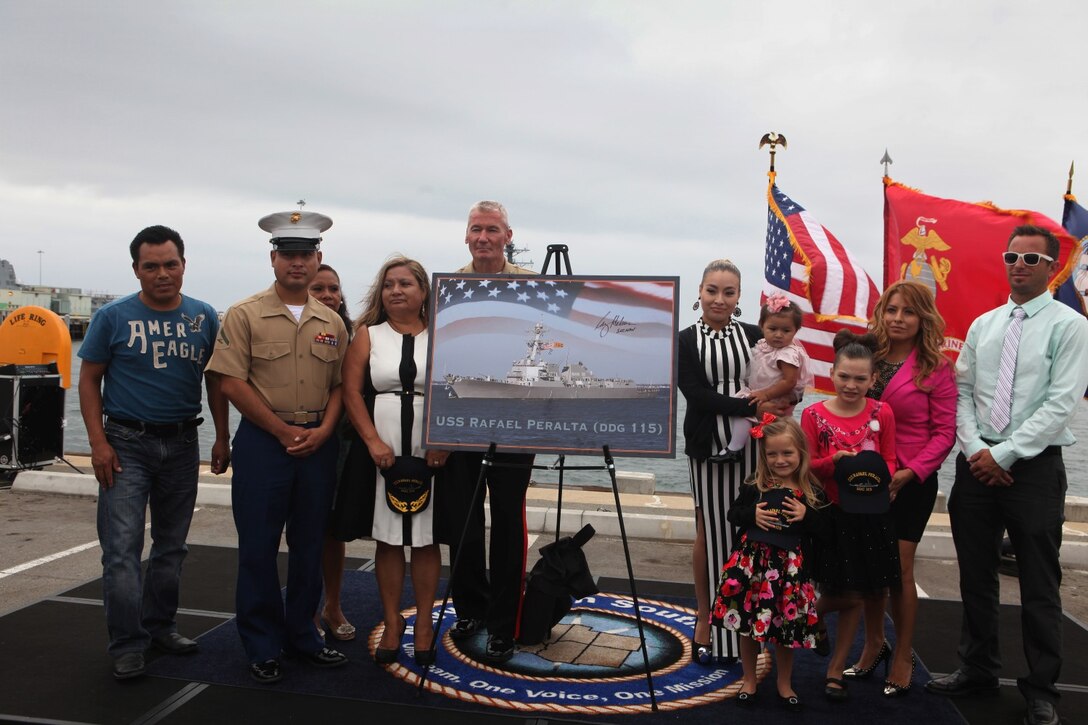 I Marine Expeditionary Force commanding general, Lt. Gen. John A. Toolan, is photographed with  the family of Navy Cross recipient Sgt. Rafael Peralta after a ship naming ceremony aboard Naval Base San Diego, Calif., Sept. 20. Peralta, a Mexican immigrant who joined the Marine Corps as soon as he obtained his green card in 2000, deployed to Iraq with 1st Battalion, 3rd Marine Regiment, and soon found himself in urban warfare during the second battle of Fallujah. On Nov. 15, 2004, Peralta and his squad were clearing a house when he was fired upon. He fell to the floor fatally wounded. Despite those wounds, he noticed a grenade tossed by an insurgent, grabbed it and pressed it against his body to absorb the impact. He subsequently saved the lives of the other Marines in his squad.
