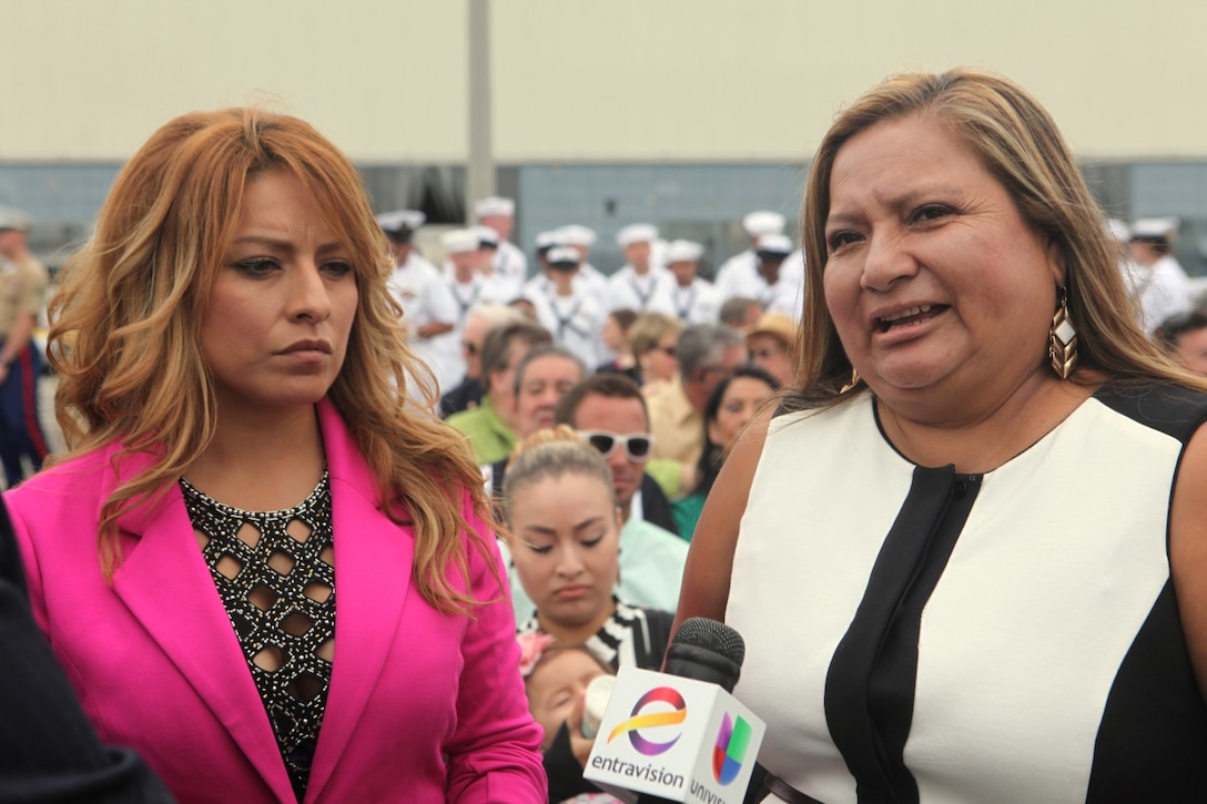Icela Donald, sister of Navy Cross recipient, Sgt. Rafael Peralta, and his mother, Rosa Peralta, are interviewed by news stations aboard Naval Base San Diego, Calif., Sept. 20. Peralta was honored during a ship-naming ceremony, the USS Rafael Peralta, the 65th Arleigh Burke-class destroyer. The Mexican immigrant who joined the Corps as soon as he obtained his green card in 2000, deployed to Iraq with 1st Battalion, 3rd Marine Regiment, and soon found himself in the middle of urban warfare during the second battle of Fallujah in 2004. Peralta and members of his squad kicked down a door and were instantly fired upon. He was fatally wounded and fell to the floor. Despite being wounded, he noticed a grenade only a foot from his head, reached out, grabbed it and placed it under his body to abosrb the impact, subsequently saving the lives of the other Marines in his squad.