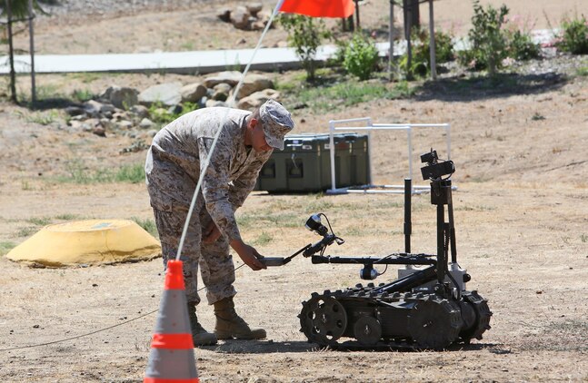 A combat engineer from Alpha Company, 7th Engineer Support Battalion, 1st Marine Logistics Group, checks a Foster-Miller TALON robot for functionality aboard Camp Pendleton, Calif., Sept. 12, 2013. The robots are used for different tasks, such as identifying objects from far distances, placing charges to blow up improvised explosive devices in place, and handling smaller objects with precision. 