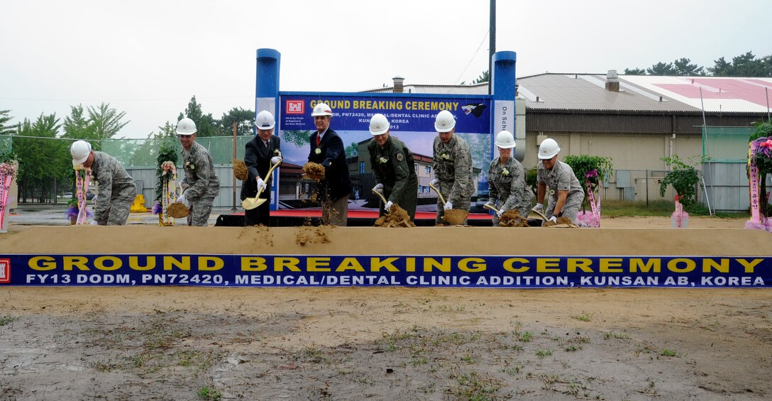 Leadership from the 8th Fighter Wing and U.S. Army Corps of Engineers Chief of Construction Sam Adkins (4th from left) break ground on a new medical facility building at Kunsan Air Base, Republic of Korea Sept. 24. The new building is scheduled to open in the Fall of 2015 and provide expanded medical support to the base.