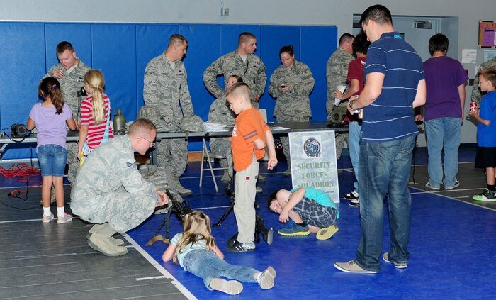 Beale youth interact with members of the 9th Security Forces Squadron during a Jr. Personnel Deployment Function Line at the Youth Center on Beale Air Force Base., Sept. 20, 2013. This event was held to give military children the experience of what their parents go through during the pre-deployment process. (U.S. Air Force photo by Senior Airman Allen Pollard/Released)