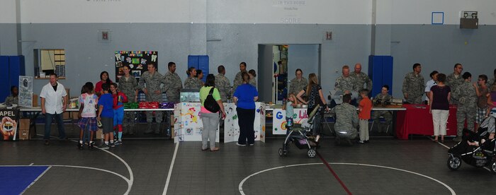 Beale youth participate in a Jr. Personnel Deployment Function Line at the Youth Center on Beale Air Force Base, Calif., Sept. 20, 2013. Children interacted with Airmen to simulate a deployment line, including receiving orders and getting fitted in protective gear. (U.S. Air Force photo by Senior Airman Allen Pollard/Released)