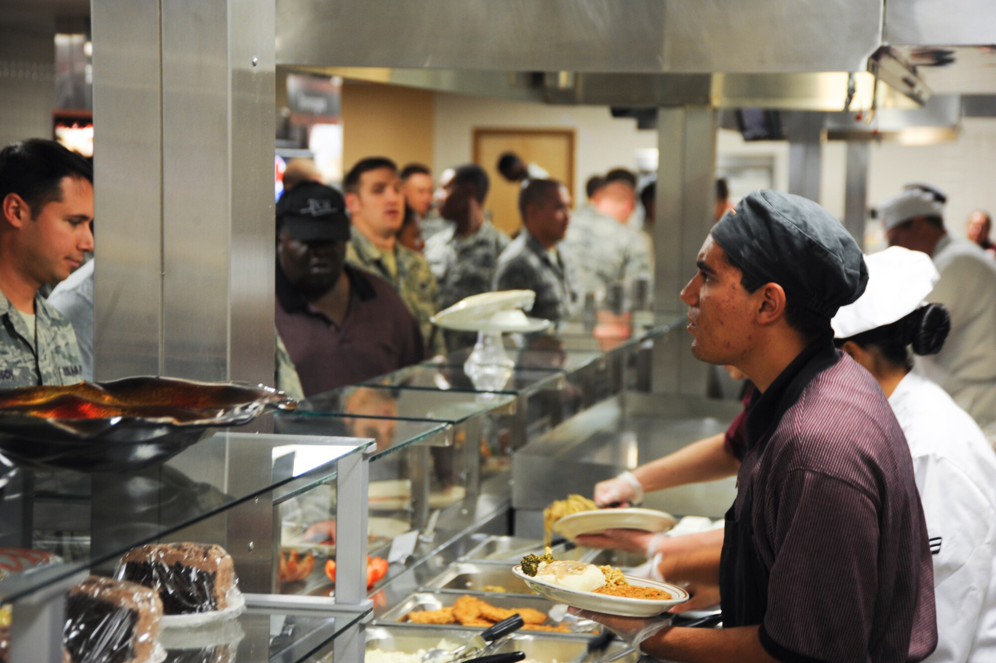 Brady Kohler, Desert Inn server, checks to see if the Airman would like anything else to eat at the Desert Inn Dining Facility at Davis-Monthan Air Force Base, Ariz., Sept. 24, 2013. In order to help the dining facility staff get a better understanding of what the Airmen want as food service options, the 355th Force Support Squadron is holding a Food Forum, Oct. 3. (U.S. Air Force photo by Airman 1st Class Justin Veazie/Released)