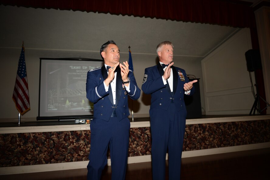 Col. David Kumashiro, 62nd Airlift Wing commander, and Chief Master Sgt. Gordon Drake, 62nd AW command chief, sing the Air Force song at the closing of the Air Force Ball, Sept. 20, 2013, at the Landmark Convention Center in Tacoma, Wash. The ball was Kumashiro’s first since taking command of the 62nd AW in July. (U. S. Air Force Photo/Airman 1st Class Jacob Jimenez)
