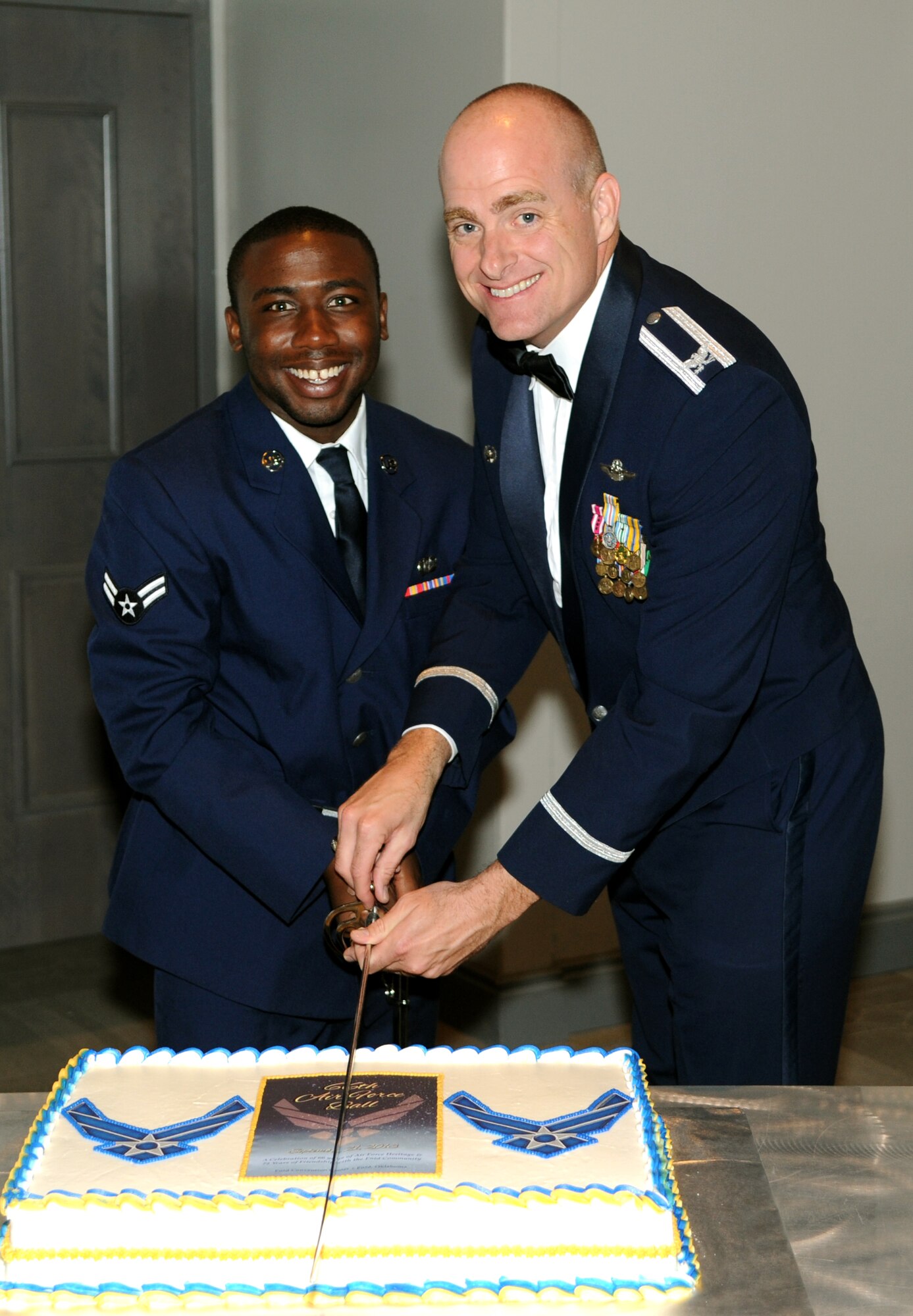 Airman 1st Class Quindarion Sands, left, with the 33rd Flying Training Squadron, and Col. Darren James, the 71st Flying Training Wing commander, cut the birthday cake during Vance Air Force Base’s celebration of the Air Force’s 66th birthday Sept. 21 at the Enid Convention Center, in Enid, Okla.  (U.S. Air Force photo/ Staff Sgt. James Bolinger)  